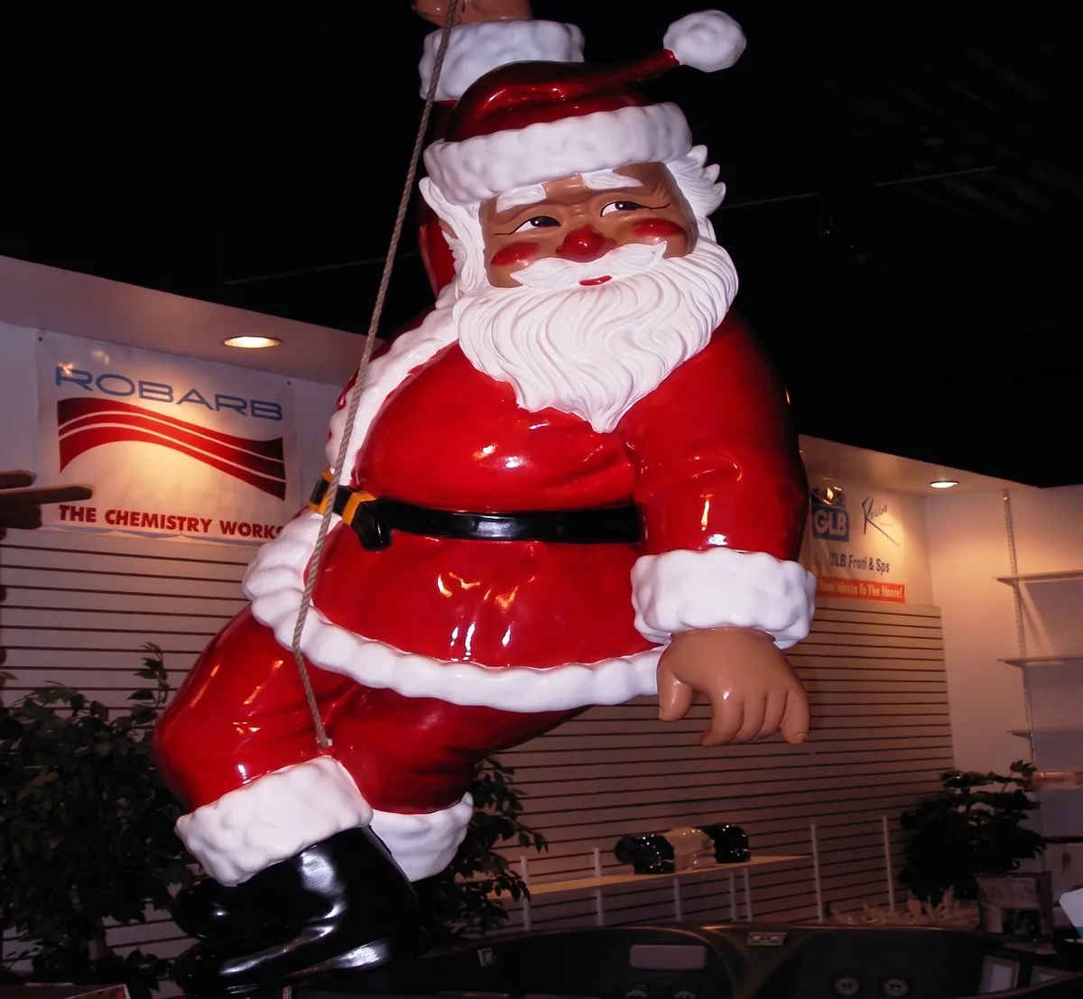 Giant Santa figure outside a lit business building